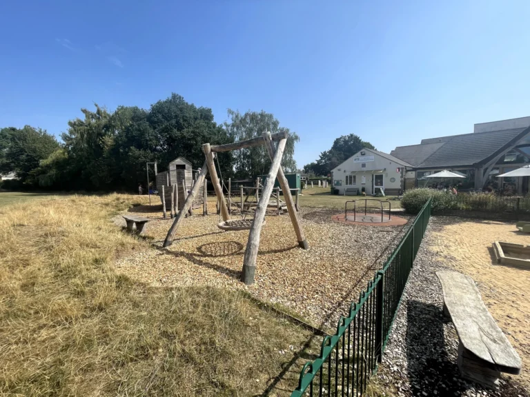 Bark-covered play area with climbing frames at The Orchard Coffee House