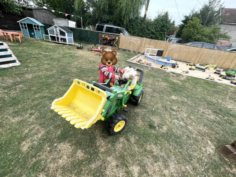 A child on a toy digger at Little Hedgehogs Play Garden
