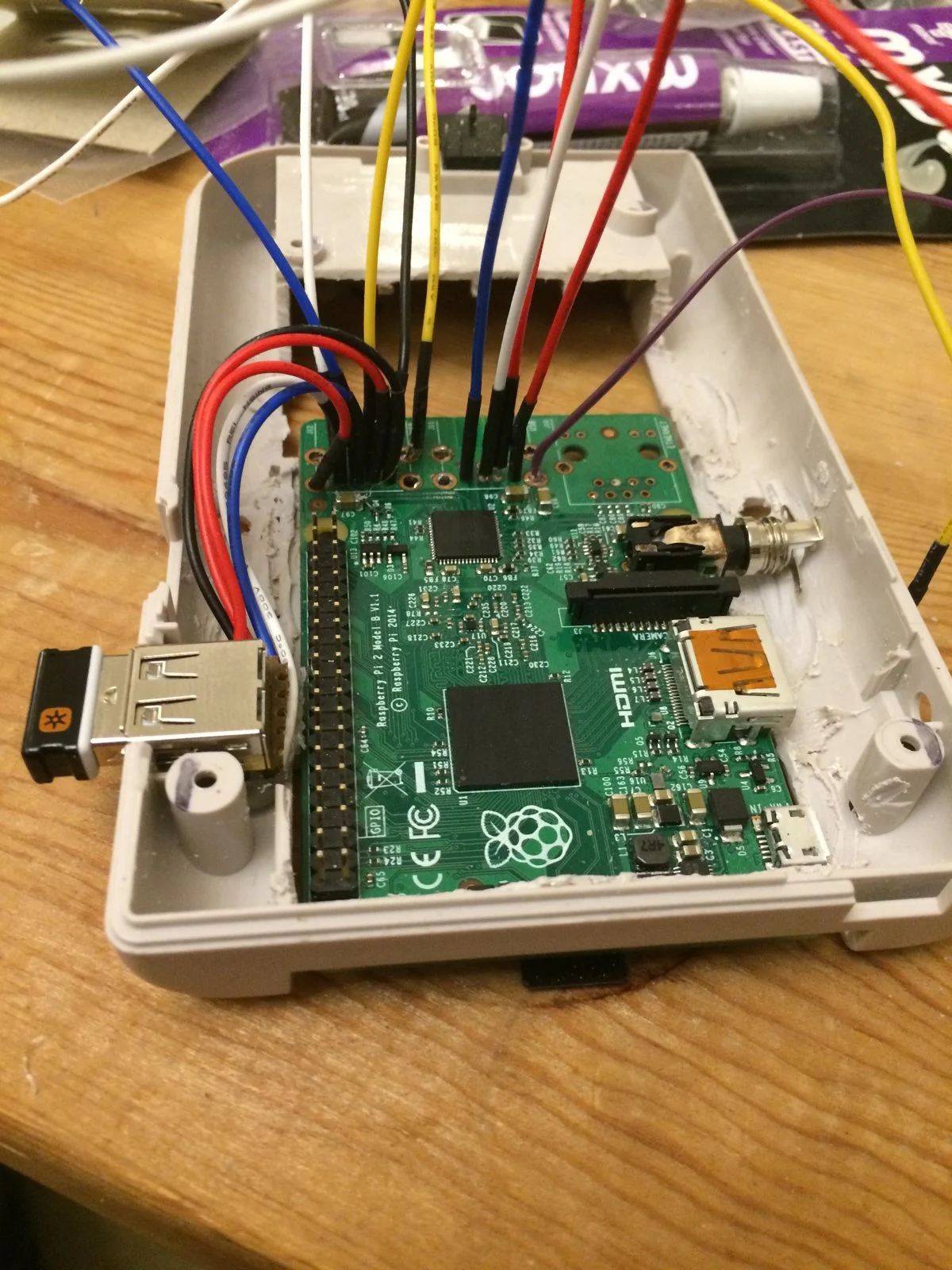 Jumper wires from the Pi's GPIO header inside the case