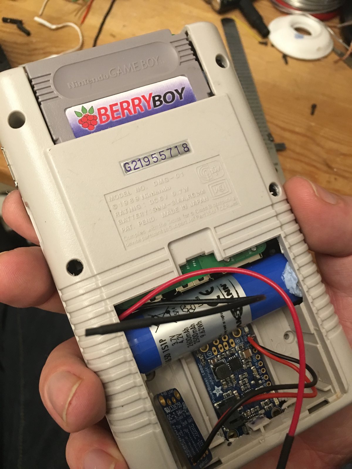 The back with the battery cover open showing the battery and boards