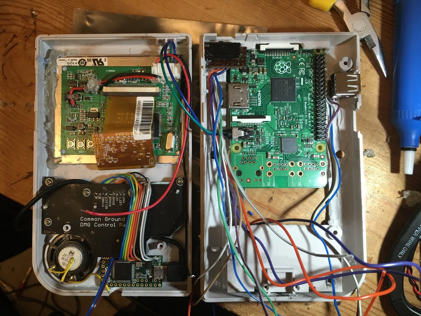 Both halves of the case packed with the Pi, screen board, control panel and wiring