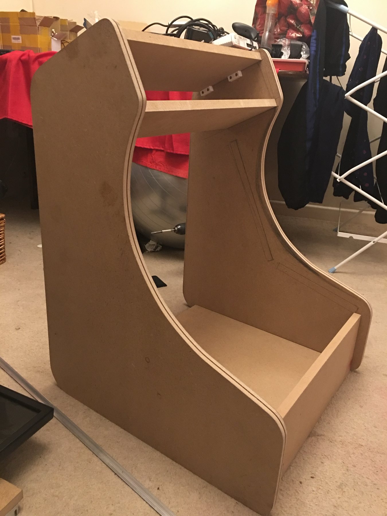 The bare MDF carcass standing on the carpet