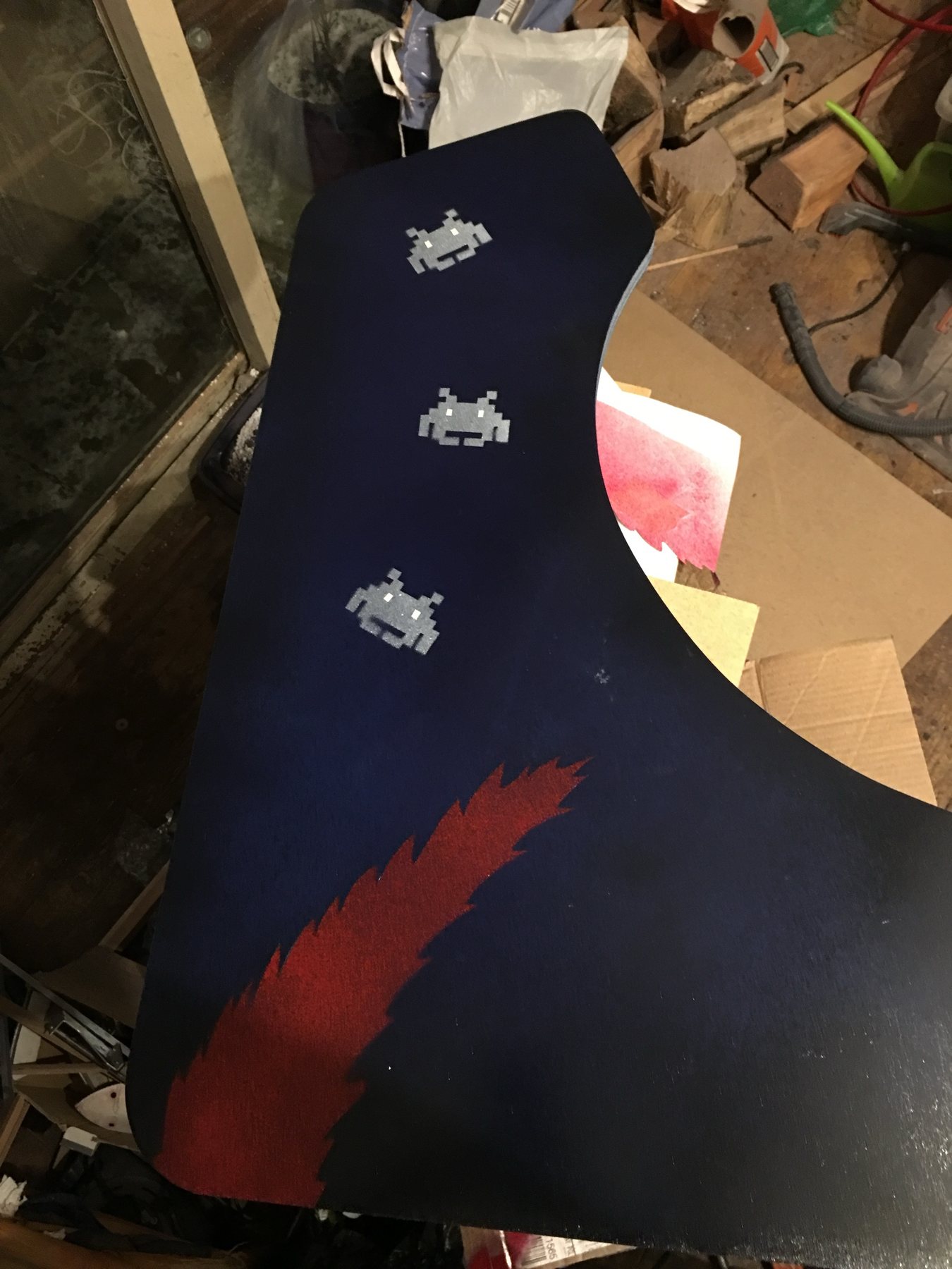 A side panel with stencilled space invaders and a red flame